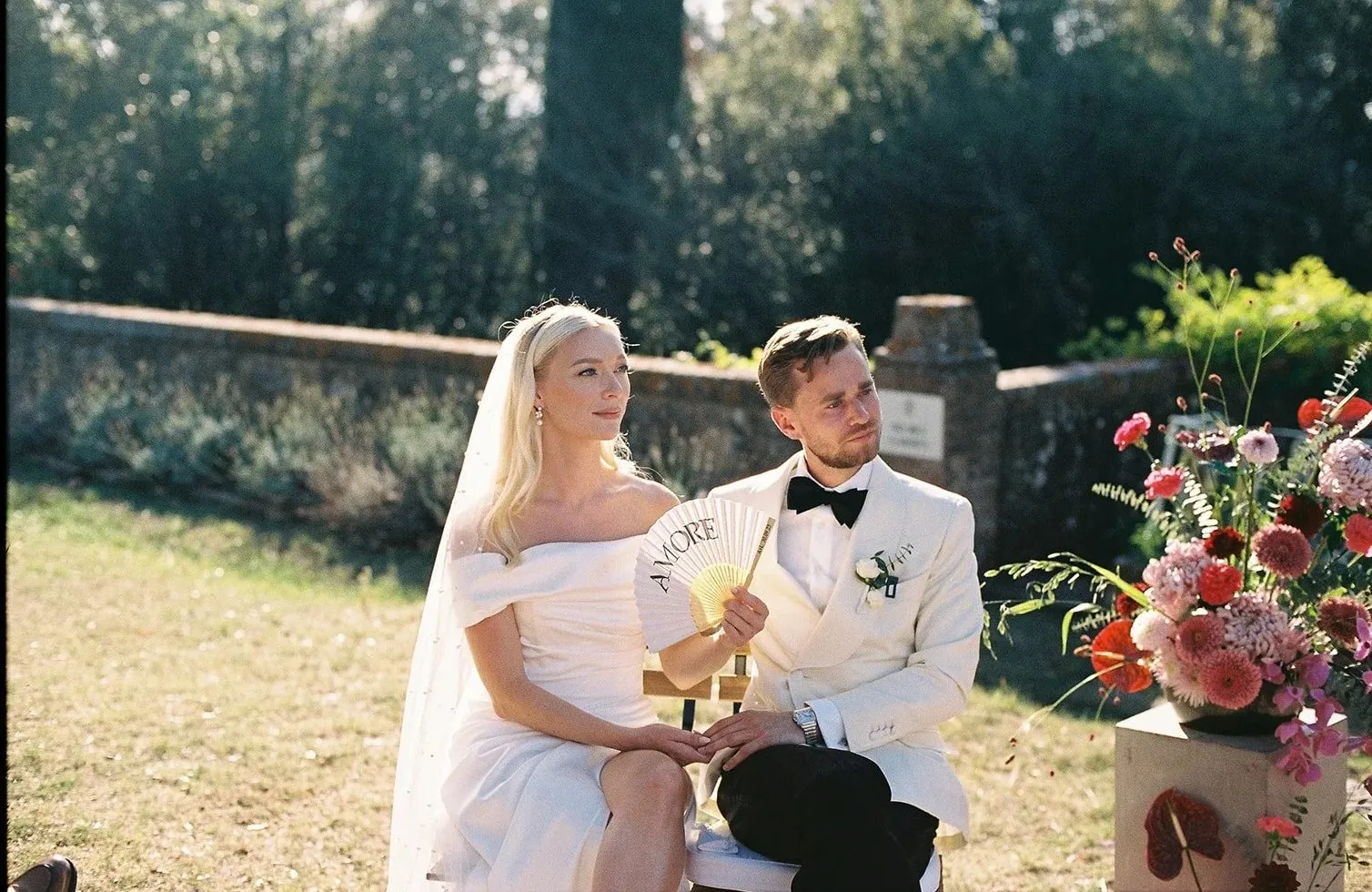 The couple seated during the ceremony