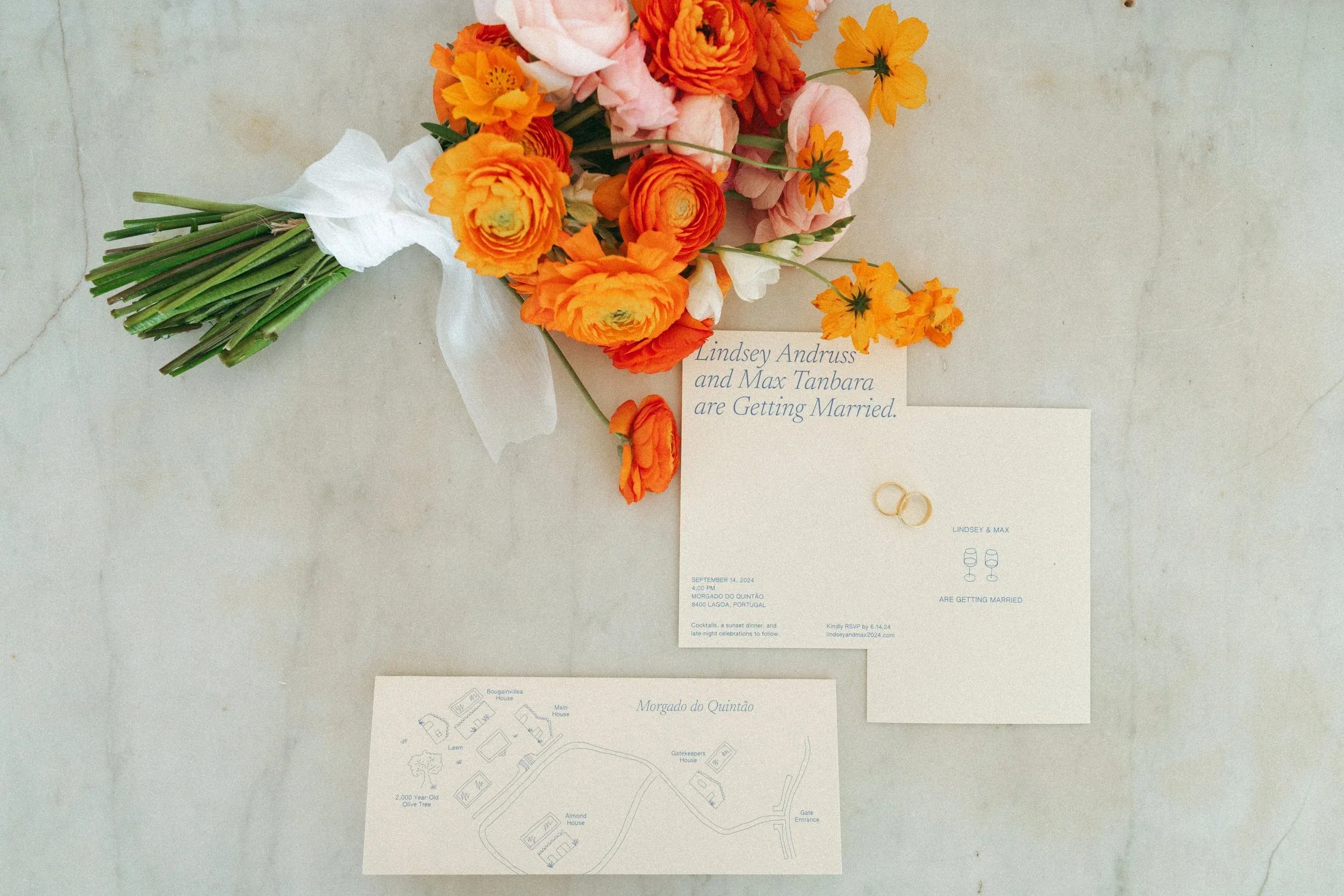 Invitations and a bouquet on marble