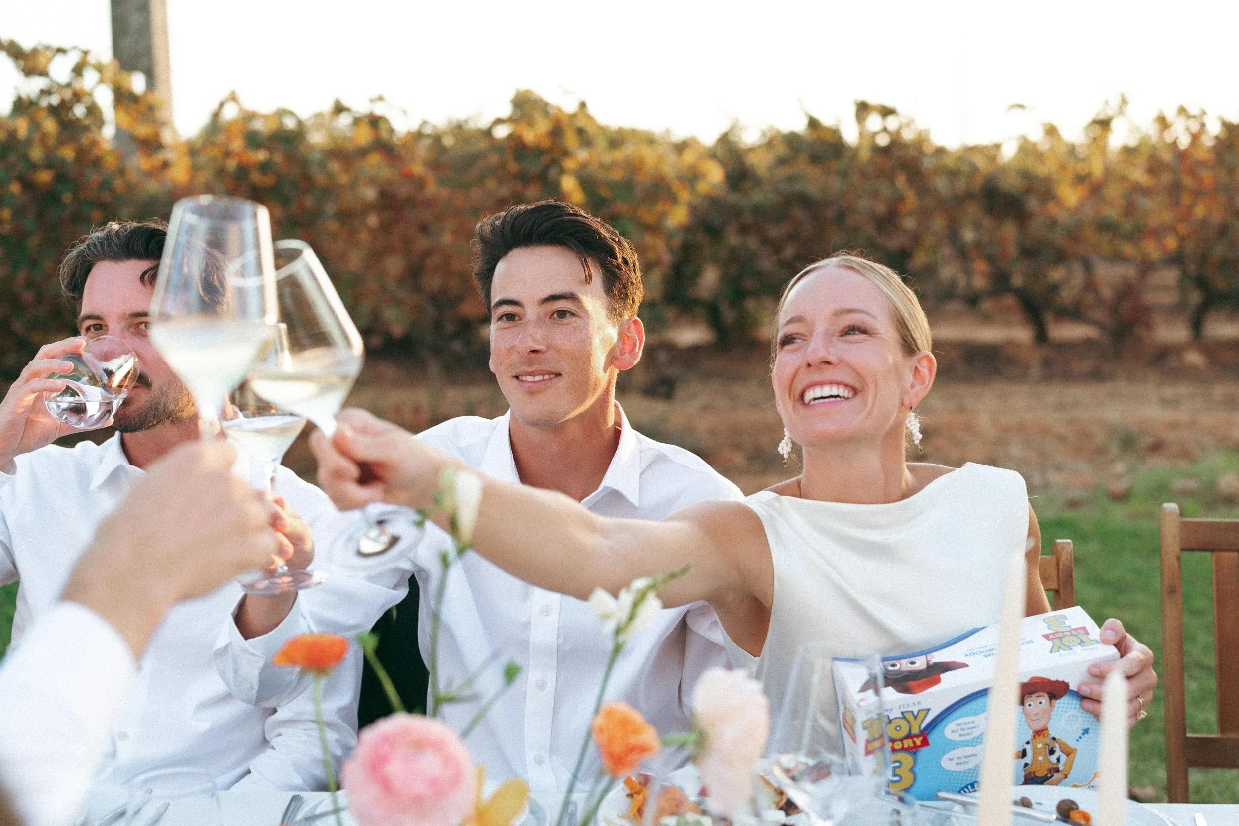 A toast at the table, everyone laughing