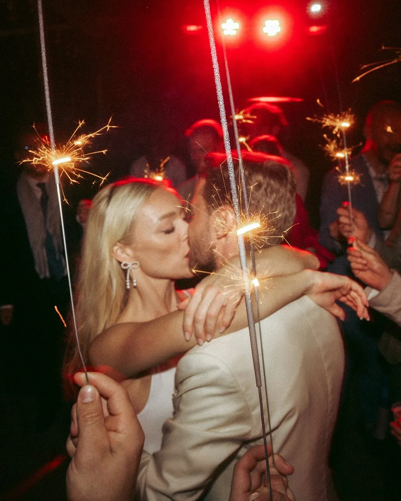Alexandra and Lukas kissing among sparklers