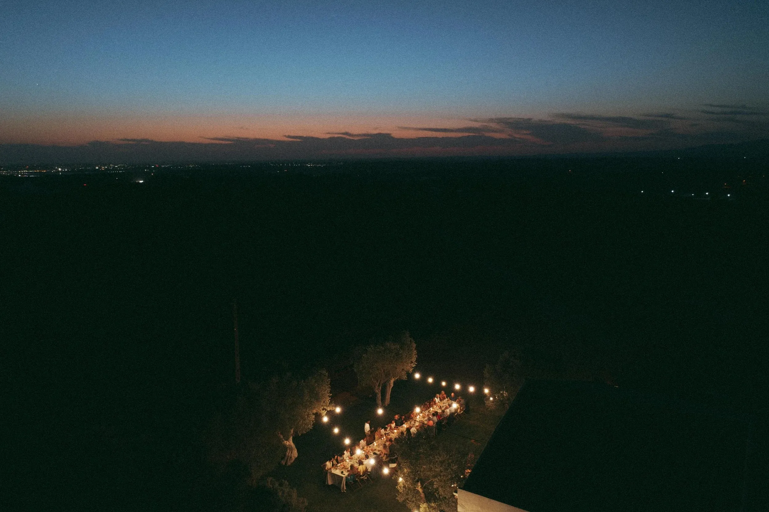 The estate at night, string lights in the trees
