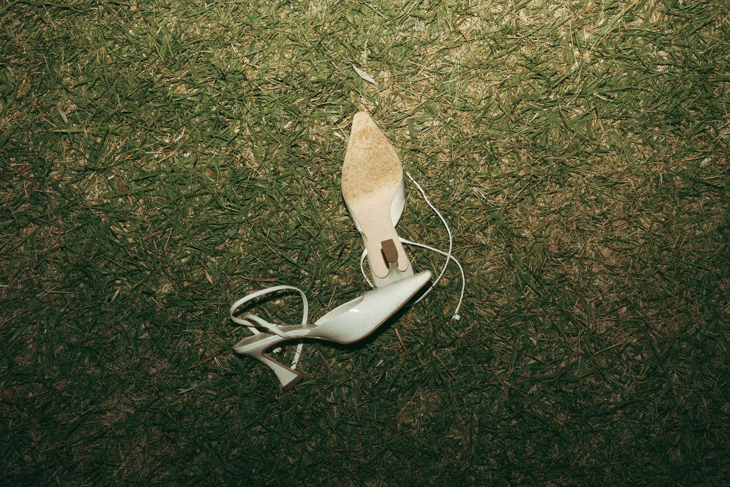 A bridal shoe left on the grass